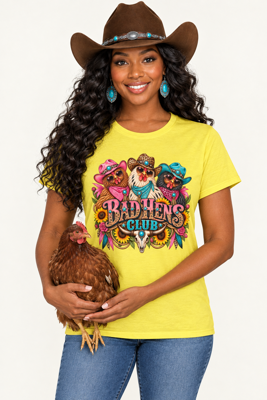 Black cowgirl in the yellow Bad Hens Club tee gently holding a chicken