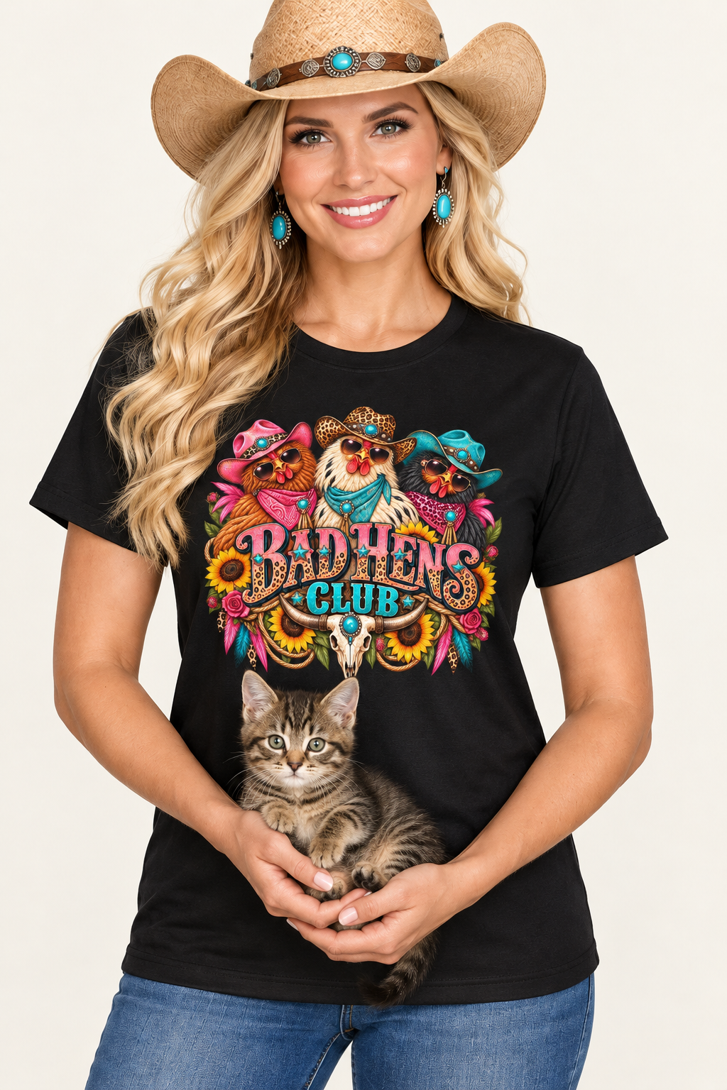 Close-up studio portrait of the cowgirl in the black Bad Hens Club tee holding a kitten