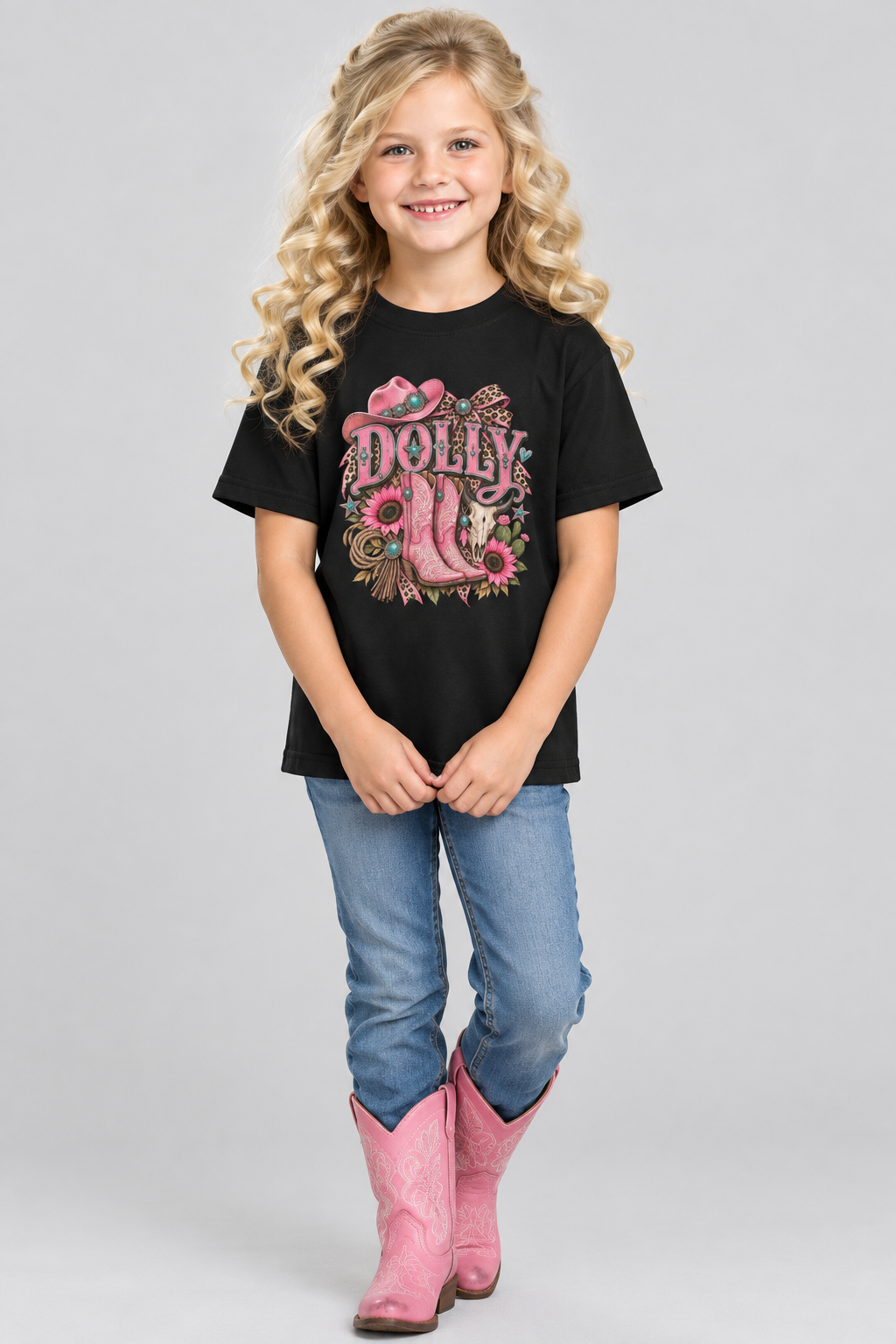 Little western girl with voluminous blonde curls wearing the black Dolly Cowgirl tee