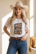 Model wearing the white Stay Wild tee in a luxury western boutique setting