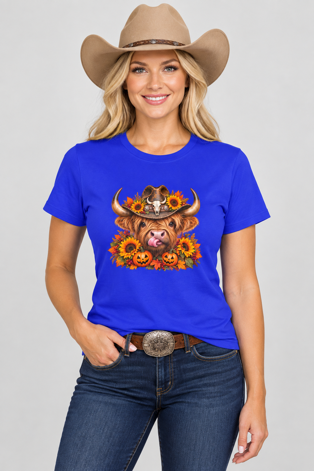 Western cowgirl wearing the royal blue Highland Cow Halloween tee in a clean studio